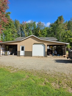 Tan pole barn with overhead door